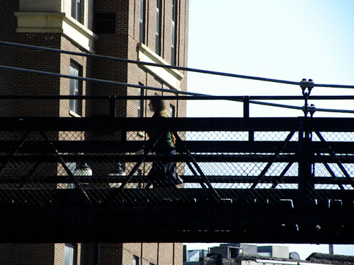 Girl walking across bridge