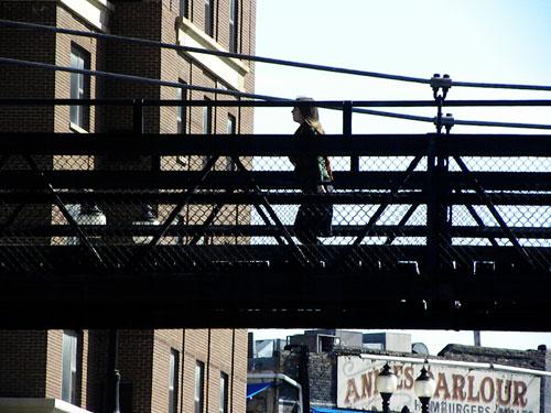 Girl walking across bridge