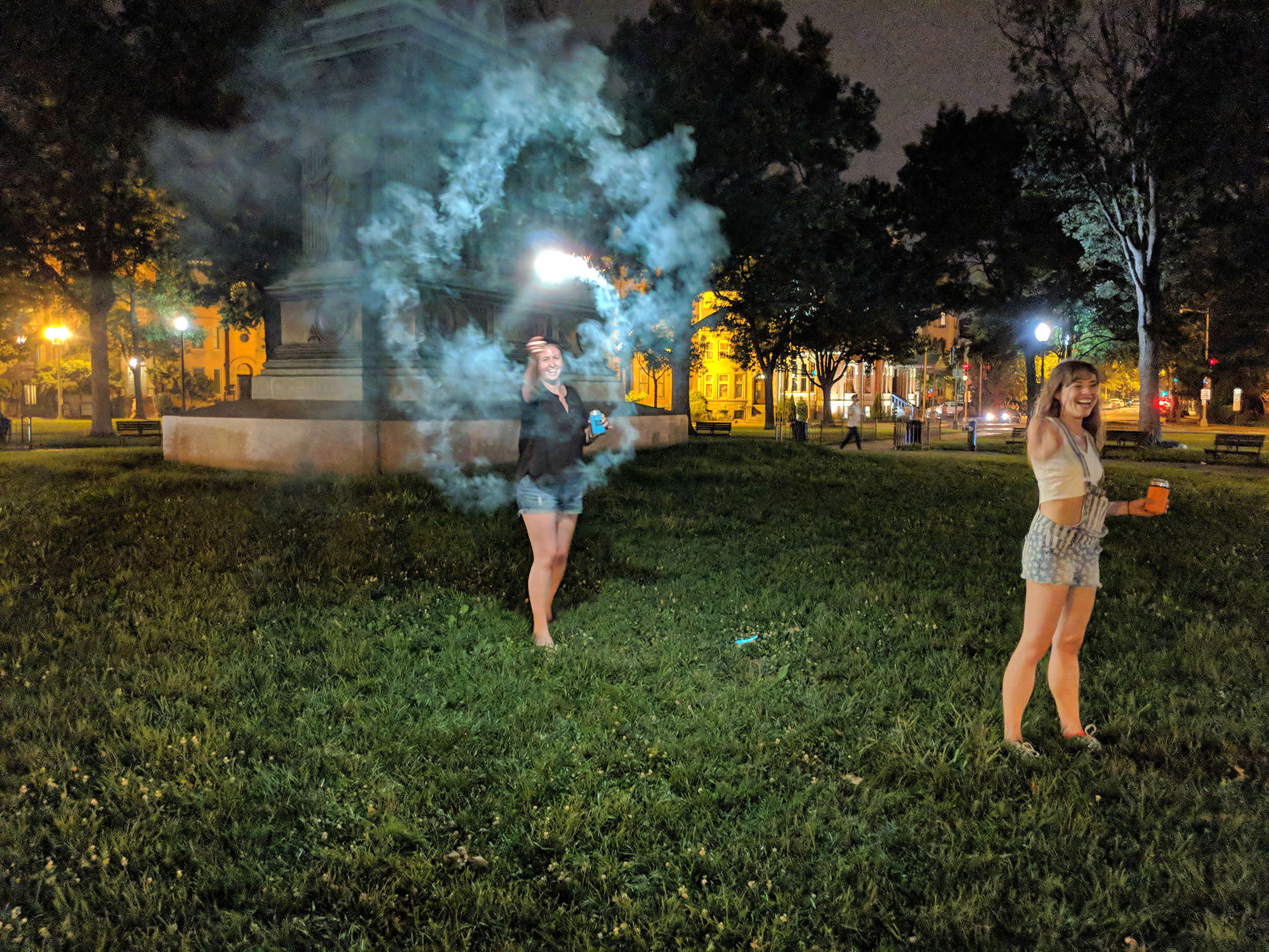 Women lighting fireworks in Logan Circle, Washington D.C.
