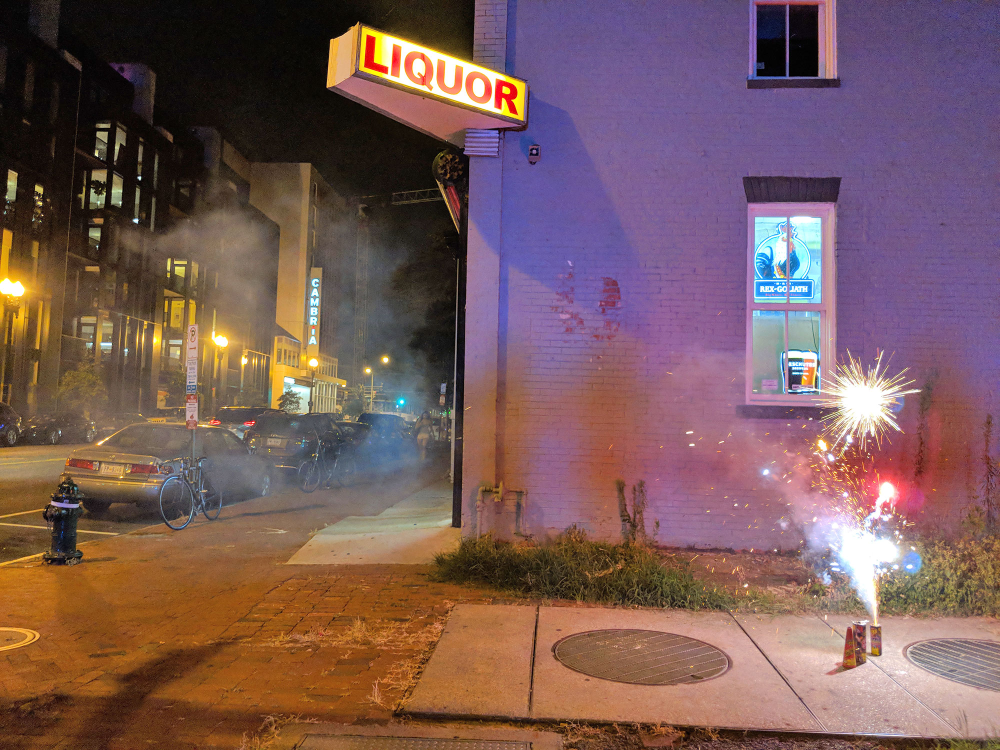 Fireworks going off in a Washington D.C. sidewalk.