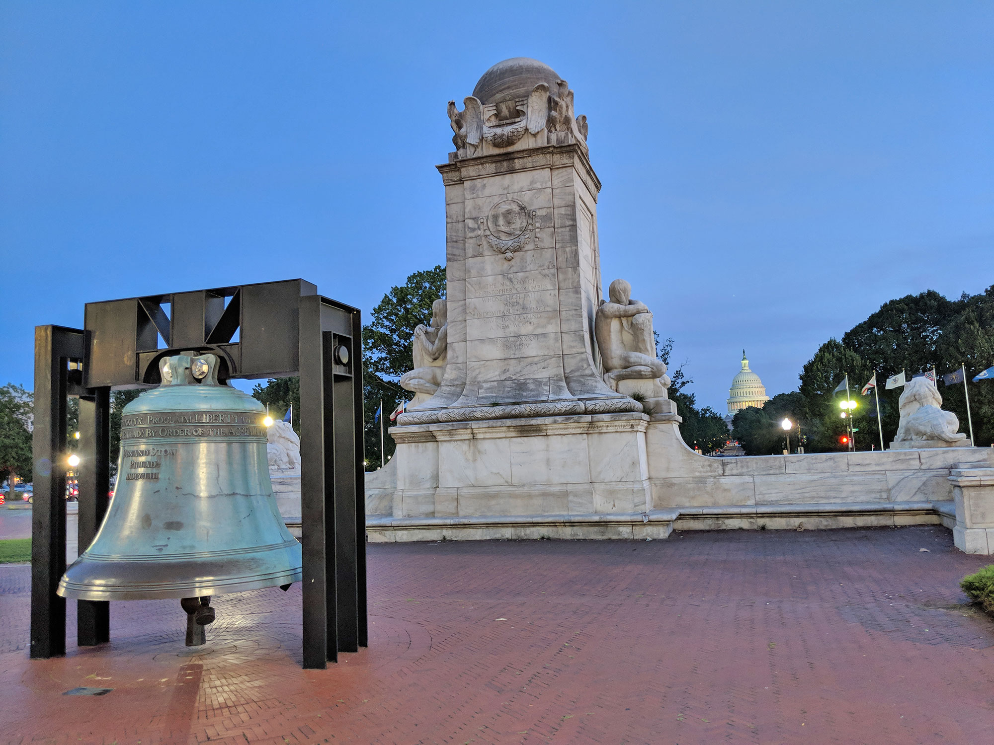 The Columbus monument and the liberty bell in front of Union Station.