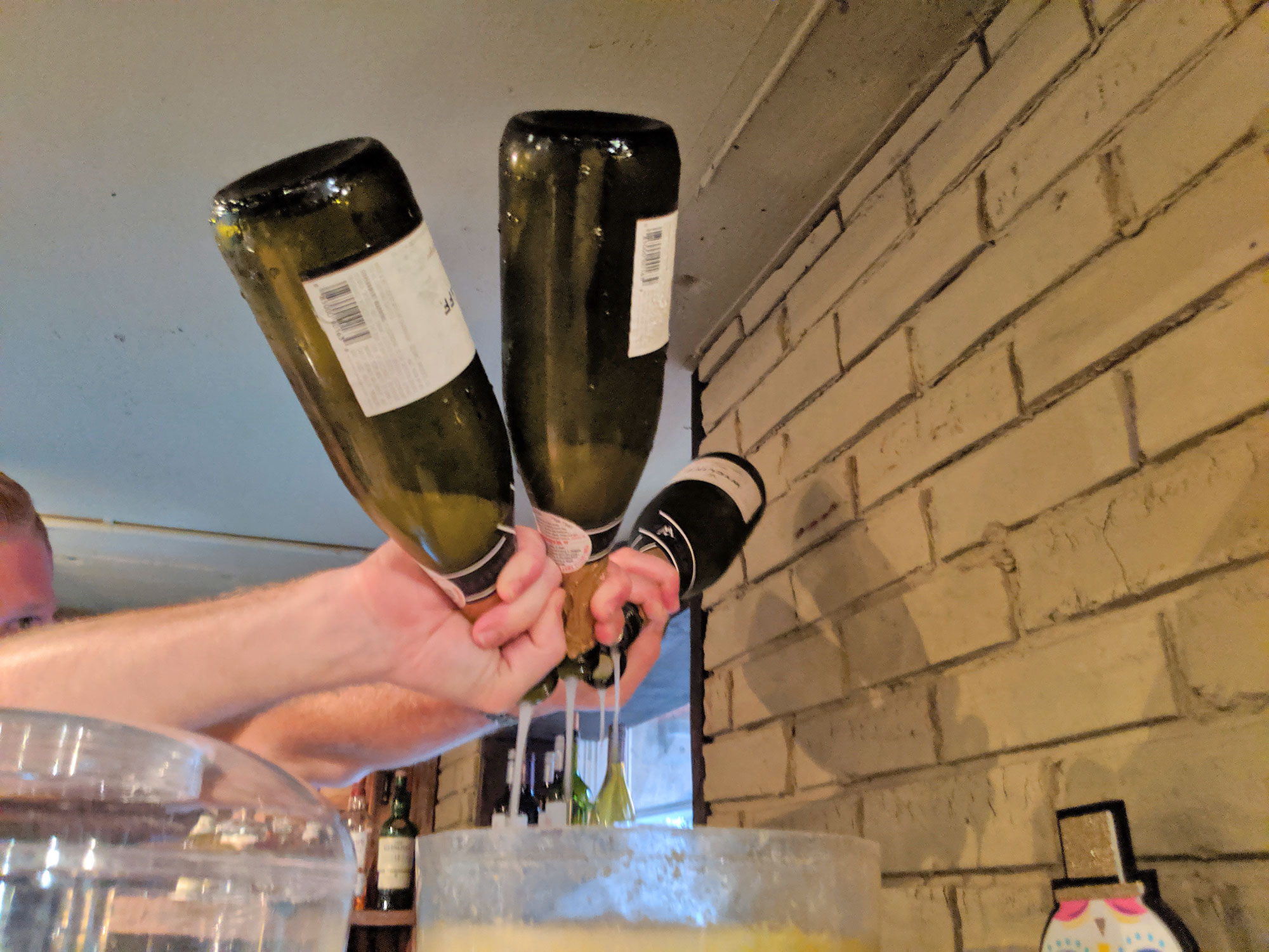 Champagne being poured at Points South Latin Kitchen drag brunch in Baltimore.