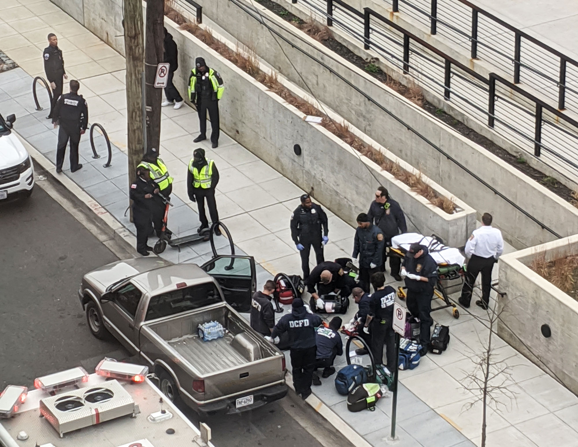 Police and firefighters rescuing a man in Ivy City, D.C.
