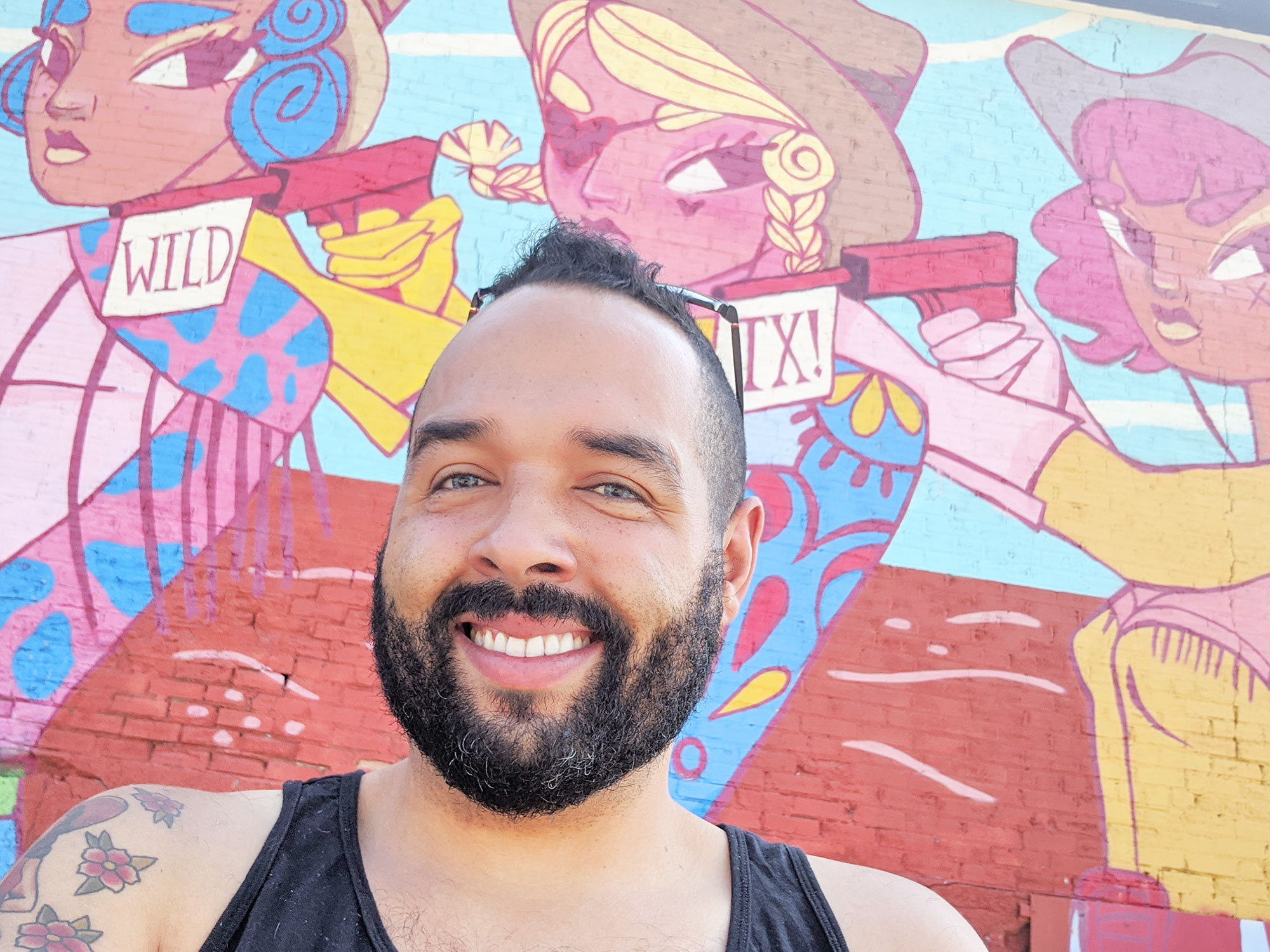 Dennis Jansen posing at a mural in Dallas, Texas.