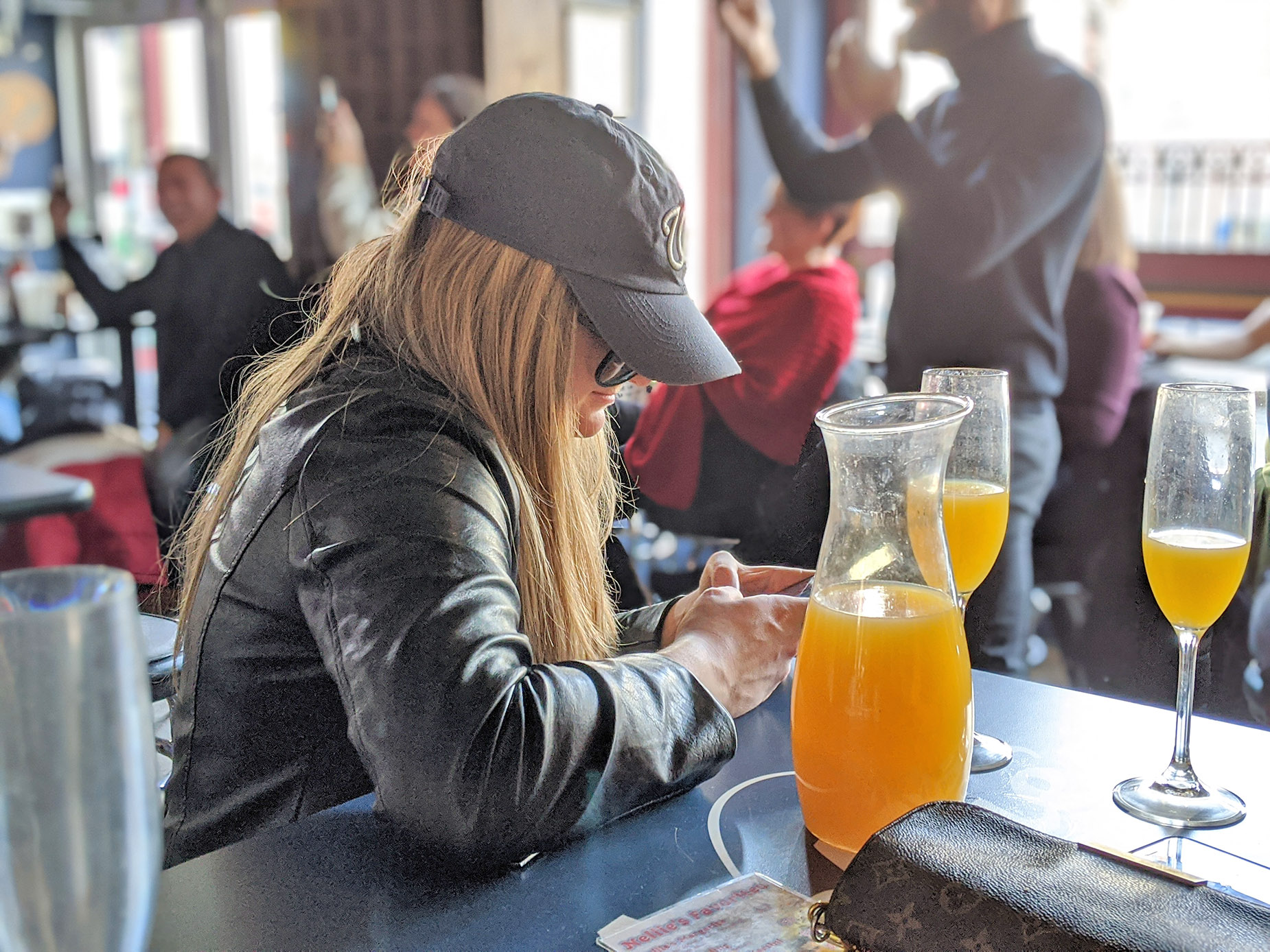 A woman possibly nursing a hangover at brunch.