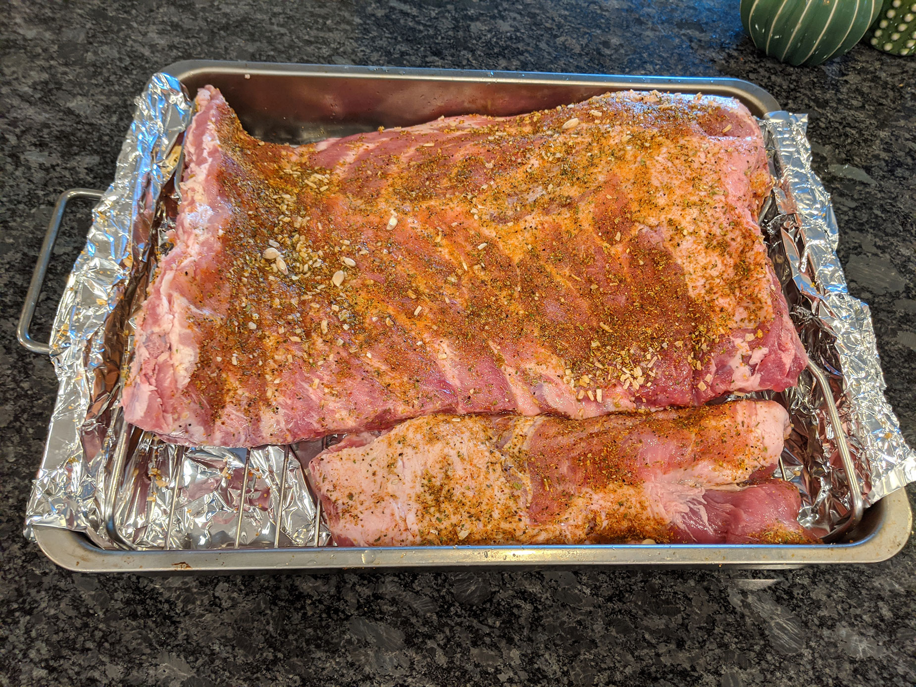 Chopping up the pork ribs to fit it into the small baking pan.