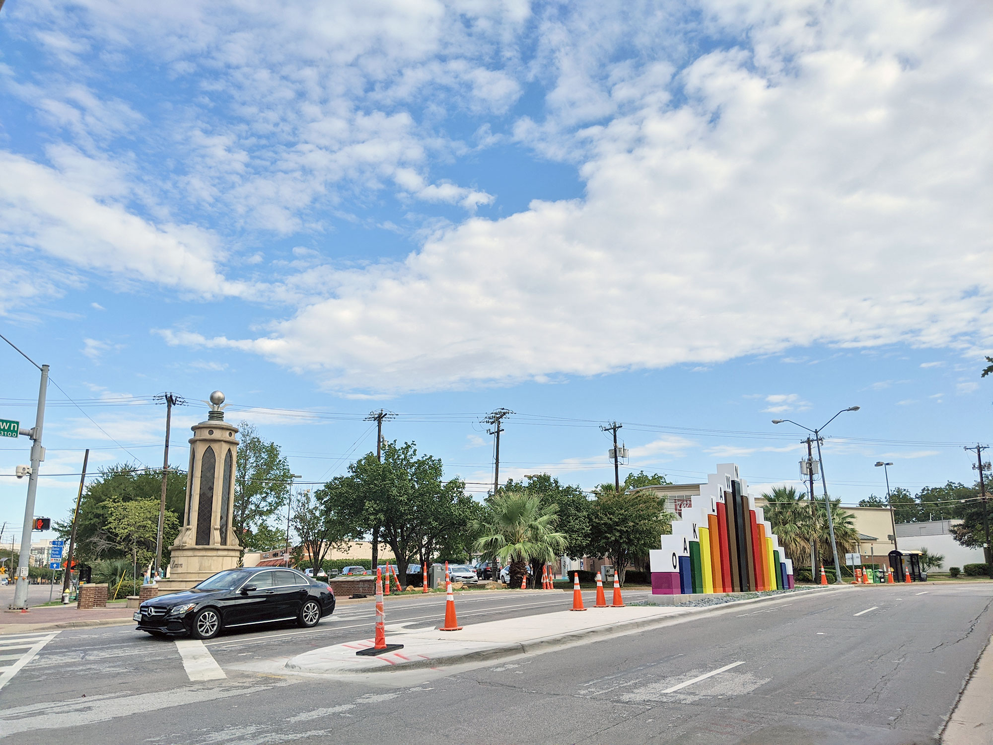 The rainbow entry sign in the Dallas gayborhood, in front of the Centrum building.